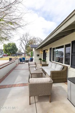 a view of a house with couches and lounge chair