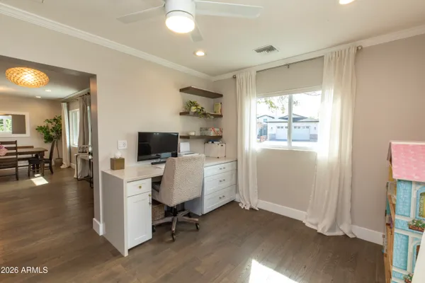a view of workspace with wooden floor and white cabinet