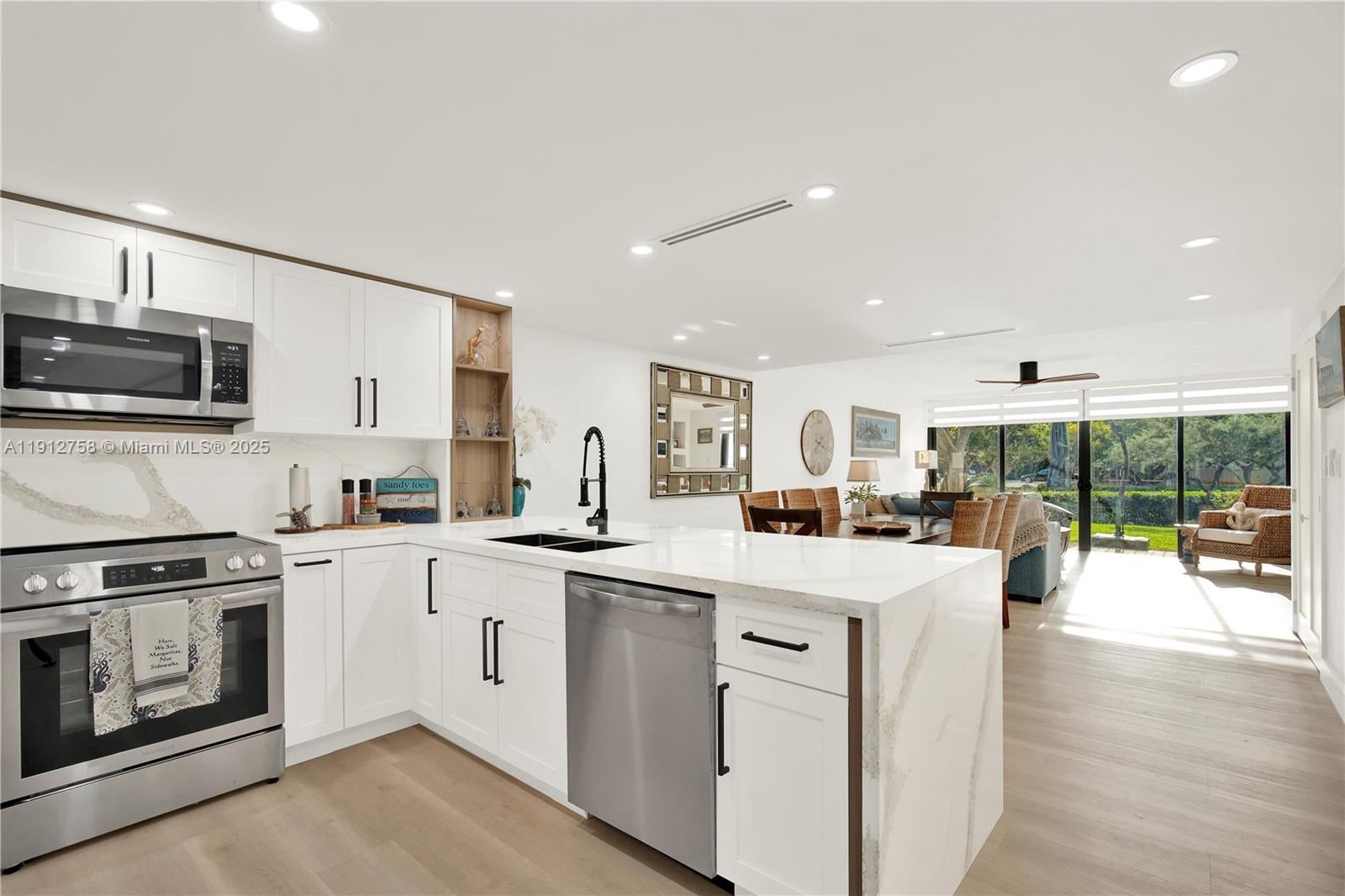 96000 Overseas Highway, Unit L5 Key Largo, FL 33037 - Photo 11 of 55 a kitchen with stainless steel appliances granite countertop a stove and a sink