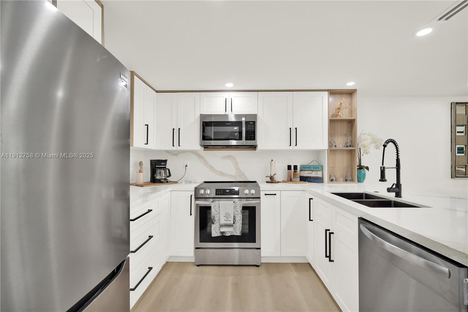 96000 Overseas Highway, Unit L5 Key Largo, FL 33037 - Photo 12 of 55 a kitchen with stainless steel appliances granite countertop a stove a sink and a refrigerator