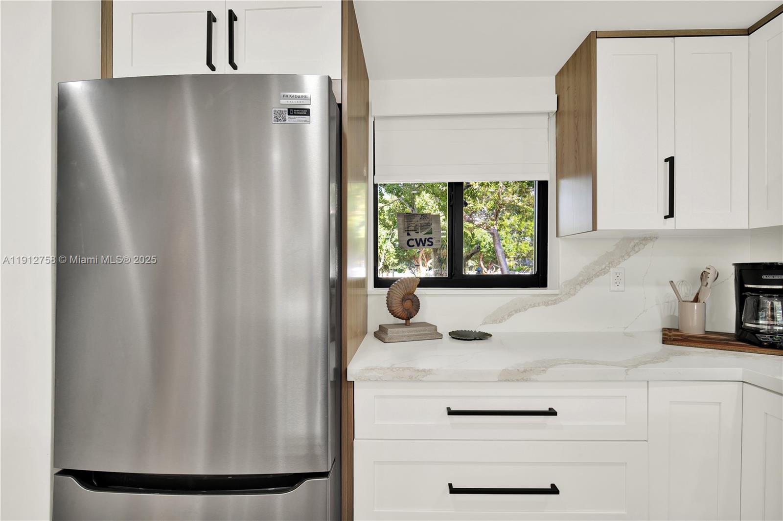 96000 Overseas Highway, Unit L5 Key Largo, FL 33037 - Photo 13 of 55 a kitchen with a refrigerator and a stove