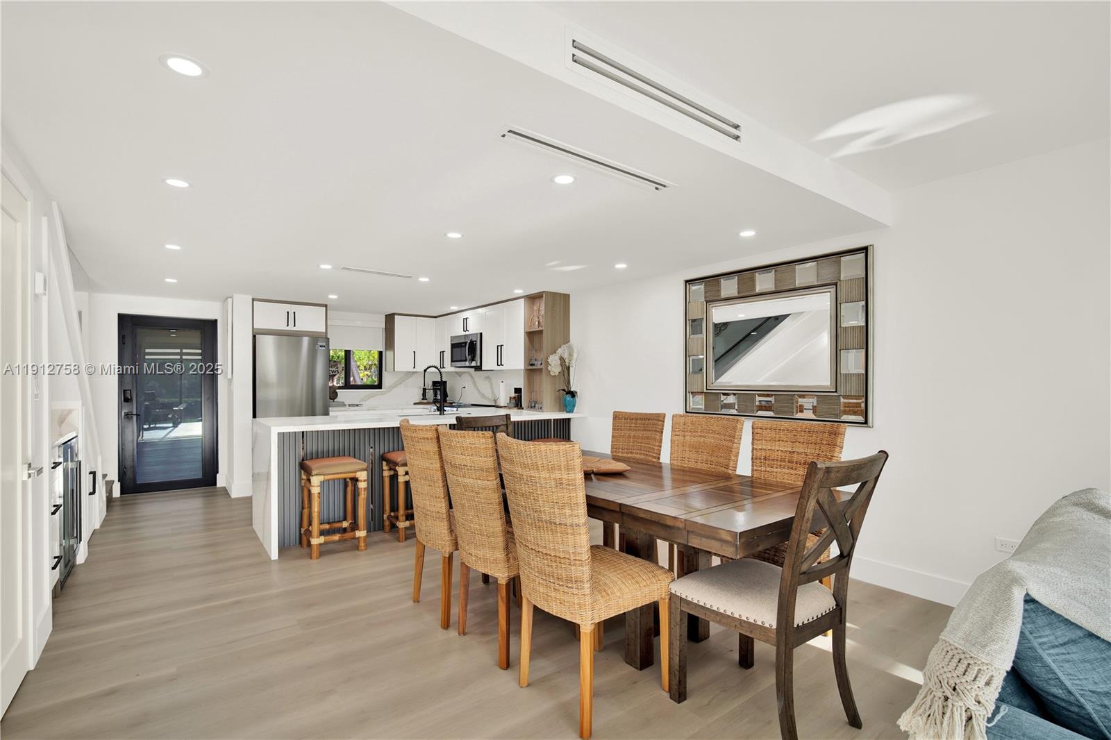 96000 Overseas Highway, Unit L5 Key Largo, FL 33037 - Photo 15 of 55 a view of a dining room with furniture and wooden floor