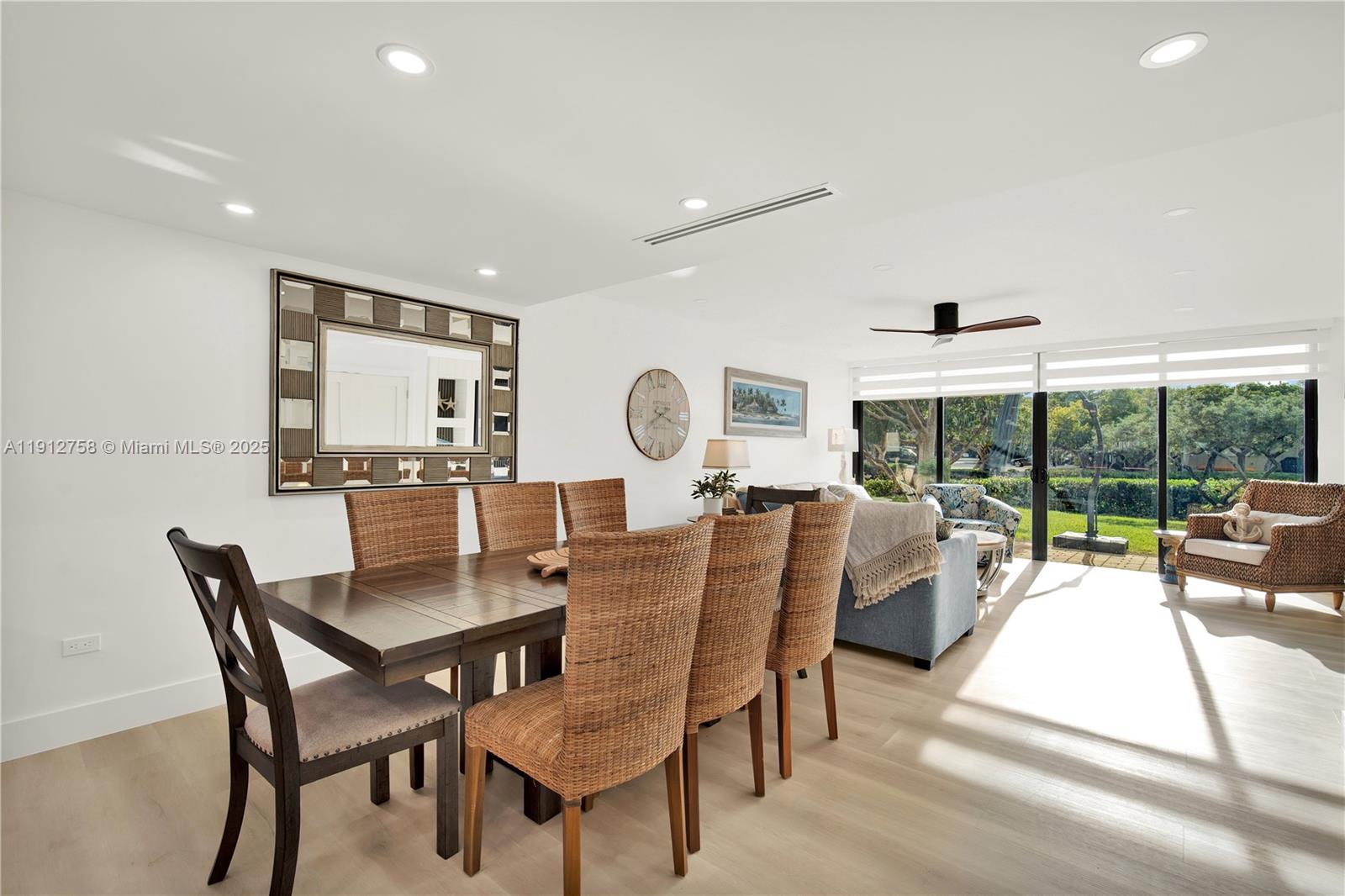 96000 Overseas Highway, Unit L5 Key Largo, FL 33037 - Photo 16 of 55 a view of a dining room with furniture large windows and wooden floor