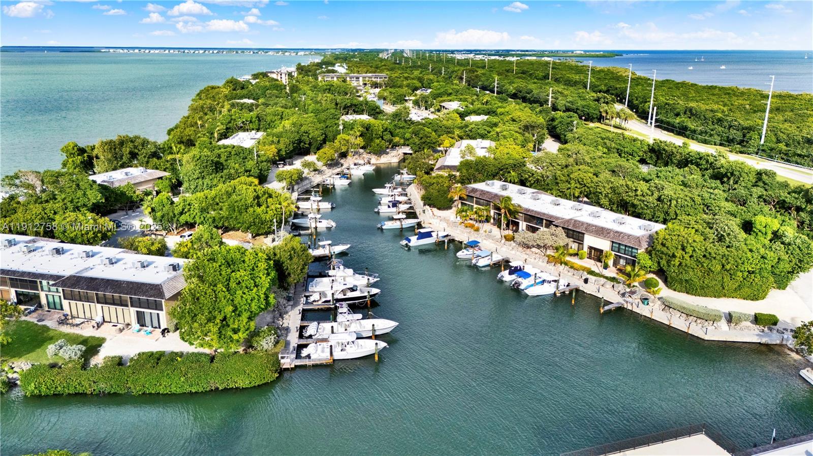 96000 Overseas Highway, Unit L5 Key Largo, FL 33037 - Photo 2 of 55 an aerial view of a house with a garden and lake view