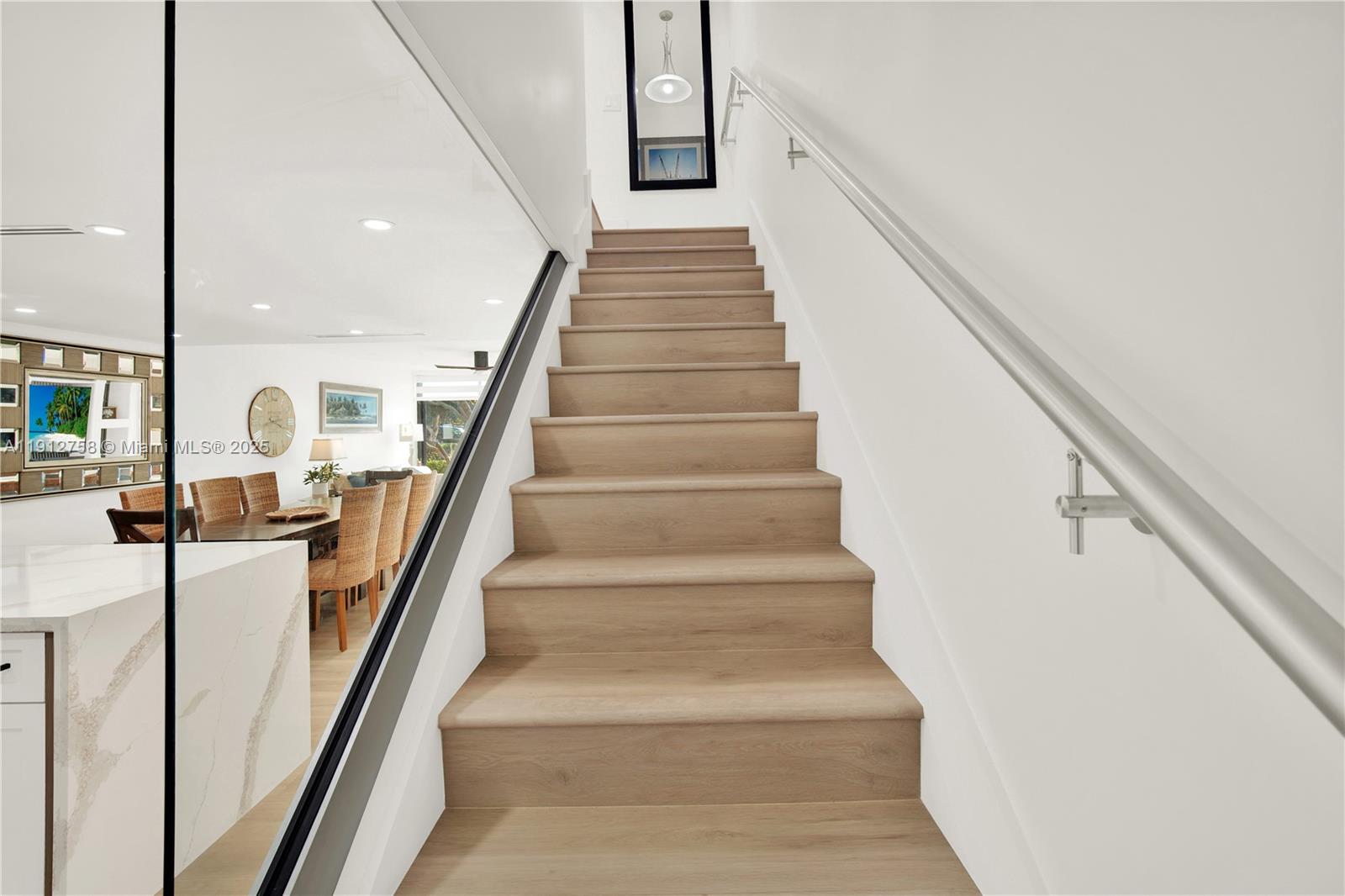 96000 Overseas Highway, Unit L5 Key Largo, FL 33037 - Photo 23 of 55 a view of staircase with lots of frames on wall and a view of gallery