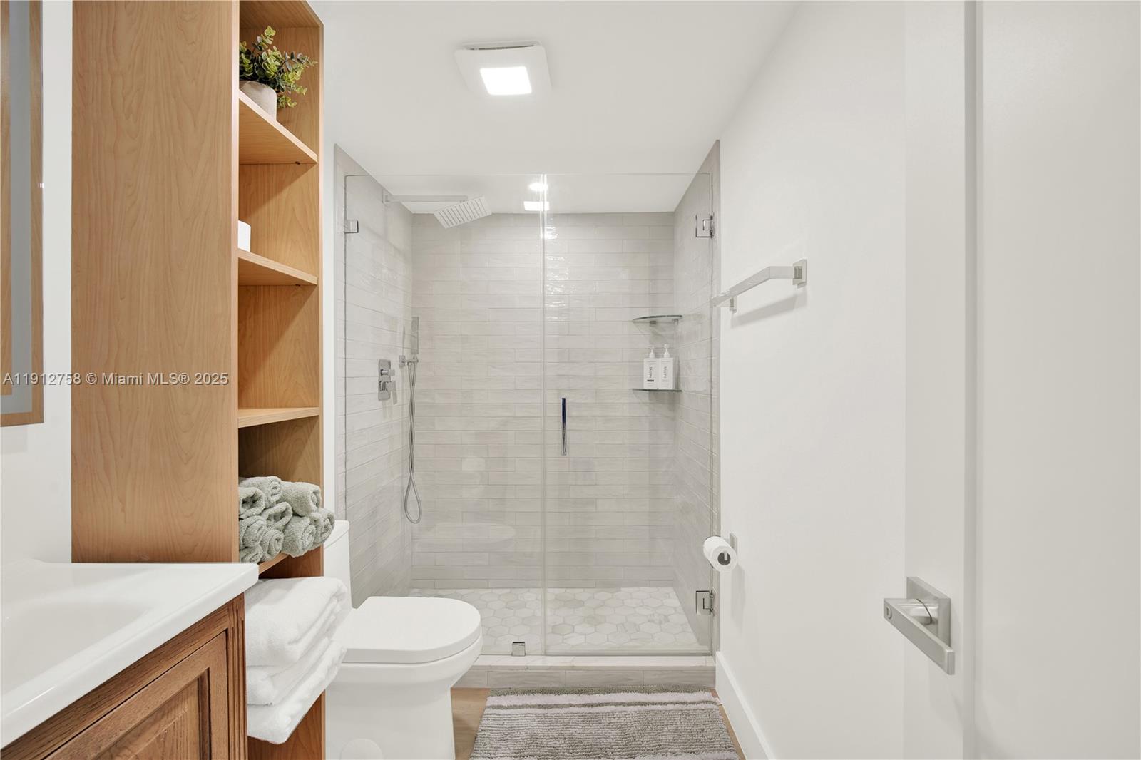 96000 Overseas Highway, Unit L5 Key Largo, FL 33037 - Photo 28 of 55 a bathroom with a granite countertop sink a toilet and shower
