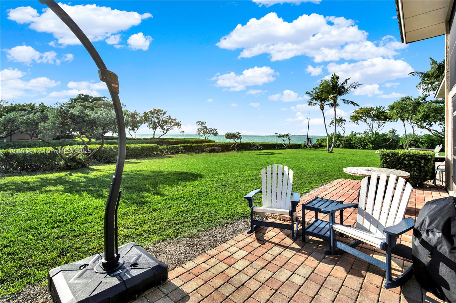 96000 Overseas Highway, Unit L5 Key Largo, FL 33037 - Photo 33 of 55 a view of a table and chairs in the garden