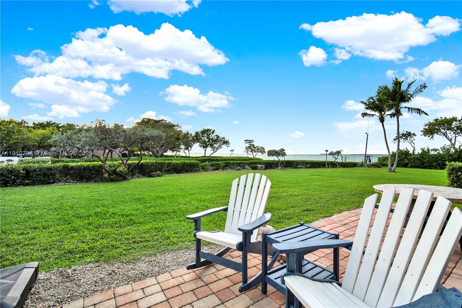 96000 Overseas Highway, Unit L5 Key Largo, FL 33037 - Photo 34 of 55 a view of a table and chairs in backyard of the house
