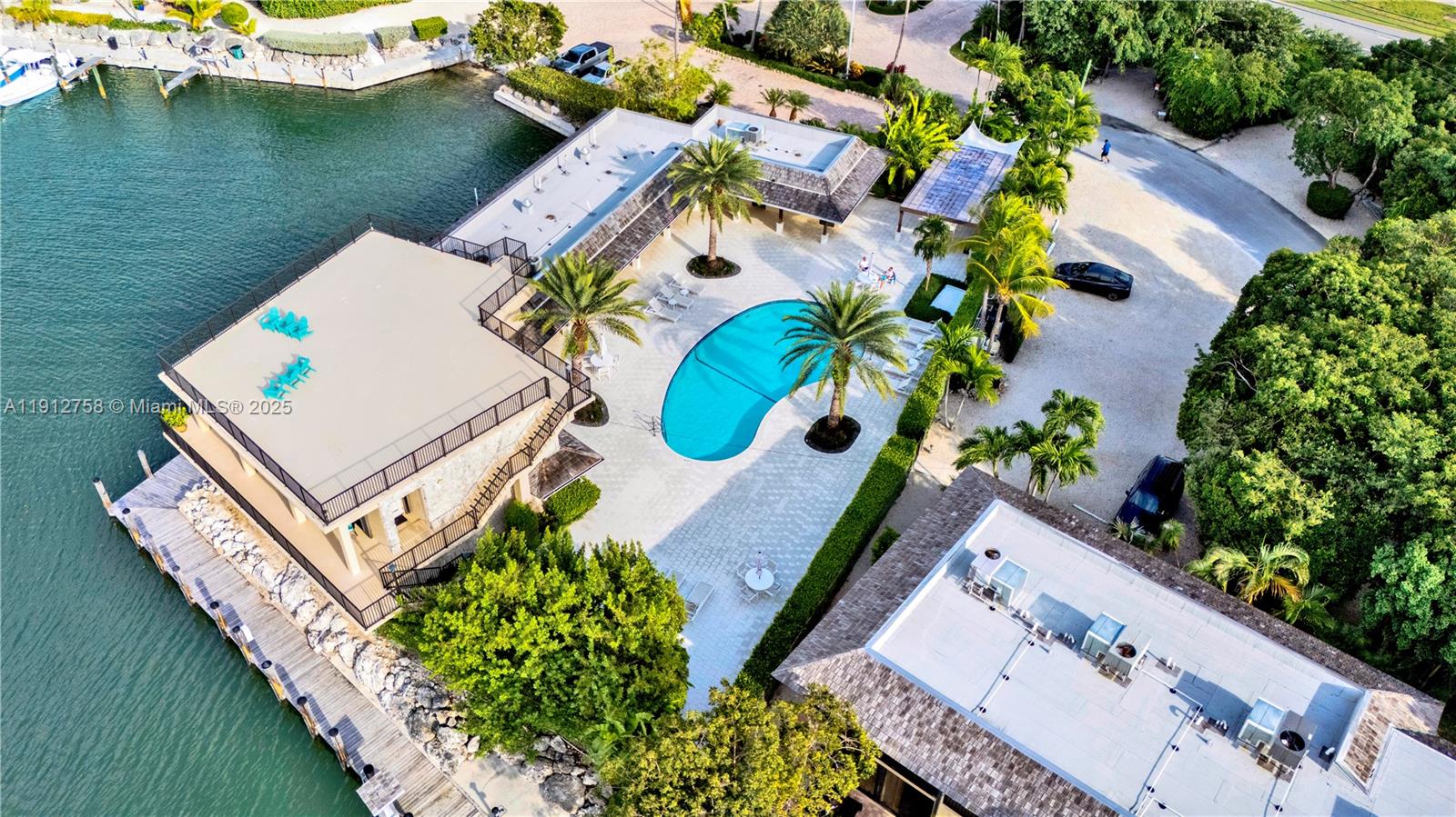 96000 Overseas Highway, Unit L5 Key Largo, FL 33037 - Photo 44 of 55 an aerial view of a house with outdoor space and a lake view