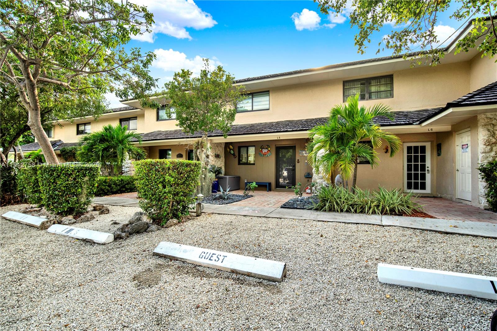 96000 Overseas Highway, Unit L5 Key Largo, FL 33037 - Photo 6 of 55 front view of a house with a yard