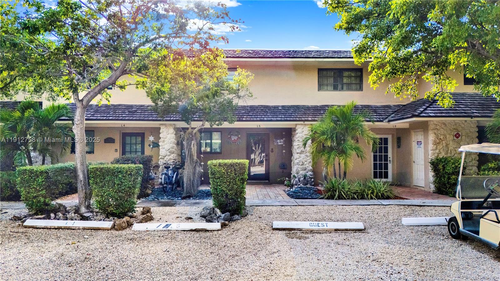 96000 Overseas Highway, Unit L5 Key Largo, FL 33037 - Photo 8 of 55 a front view of a house with garden
