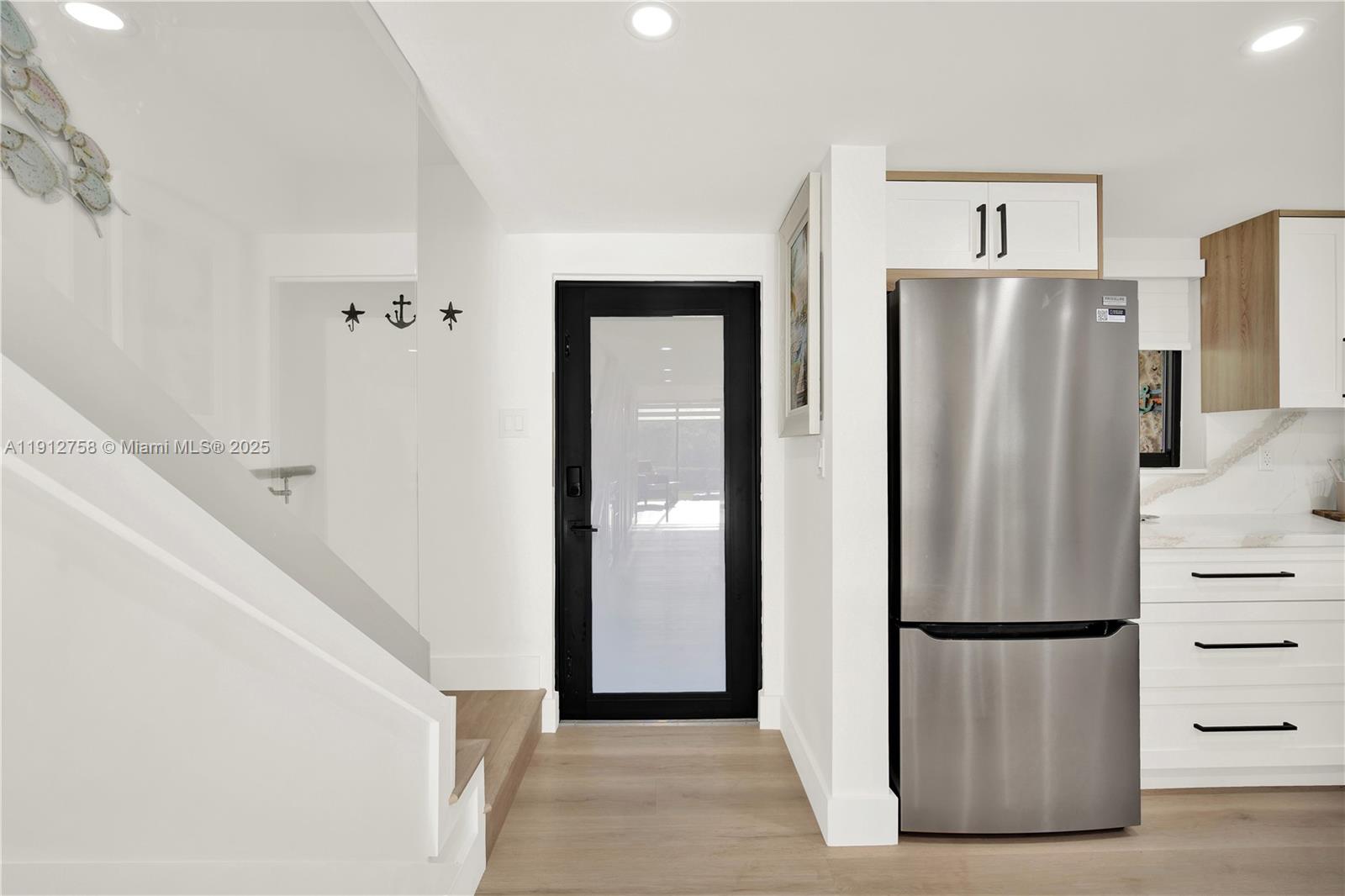 96000 Overseas Highway, Unit L5 Key Largo, FL 33037 - Photo 10 of 55 a view of kitchen with refrigerator and cabinet