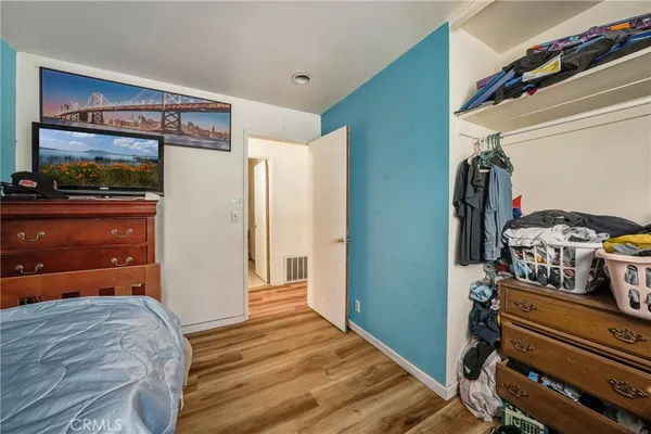 a bedroom with a bed and a dresser