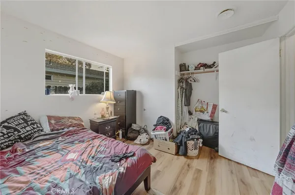 a bedroom with bed and a window