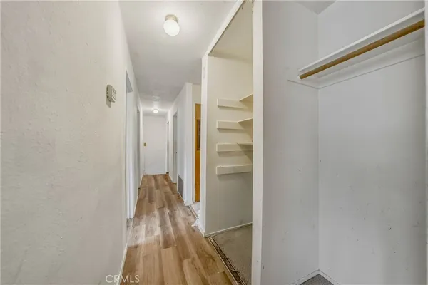 a view of hallway with wooden floor