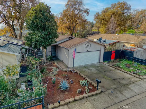 a aerial view of a house with a yard and potted plants