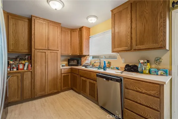 a kitchen with stainless steel appliances granite countertop a refrigerator sink and cabinets