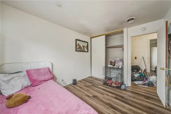 a bedroom with a bed and a large mirror