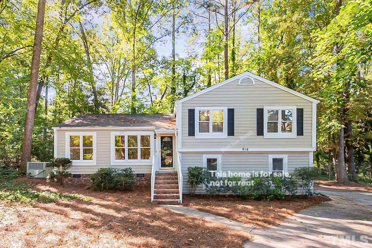 916 East Millbrook Road Raleigh, NC 27609 - Photo 1 of 24 a front view of a house with a garden