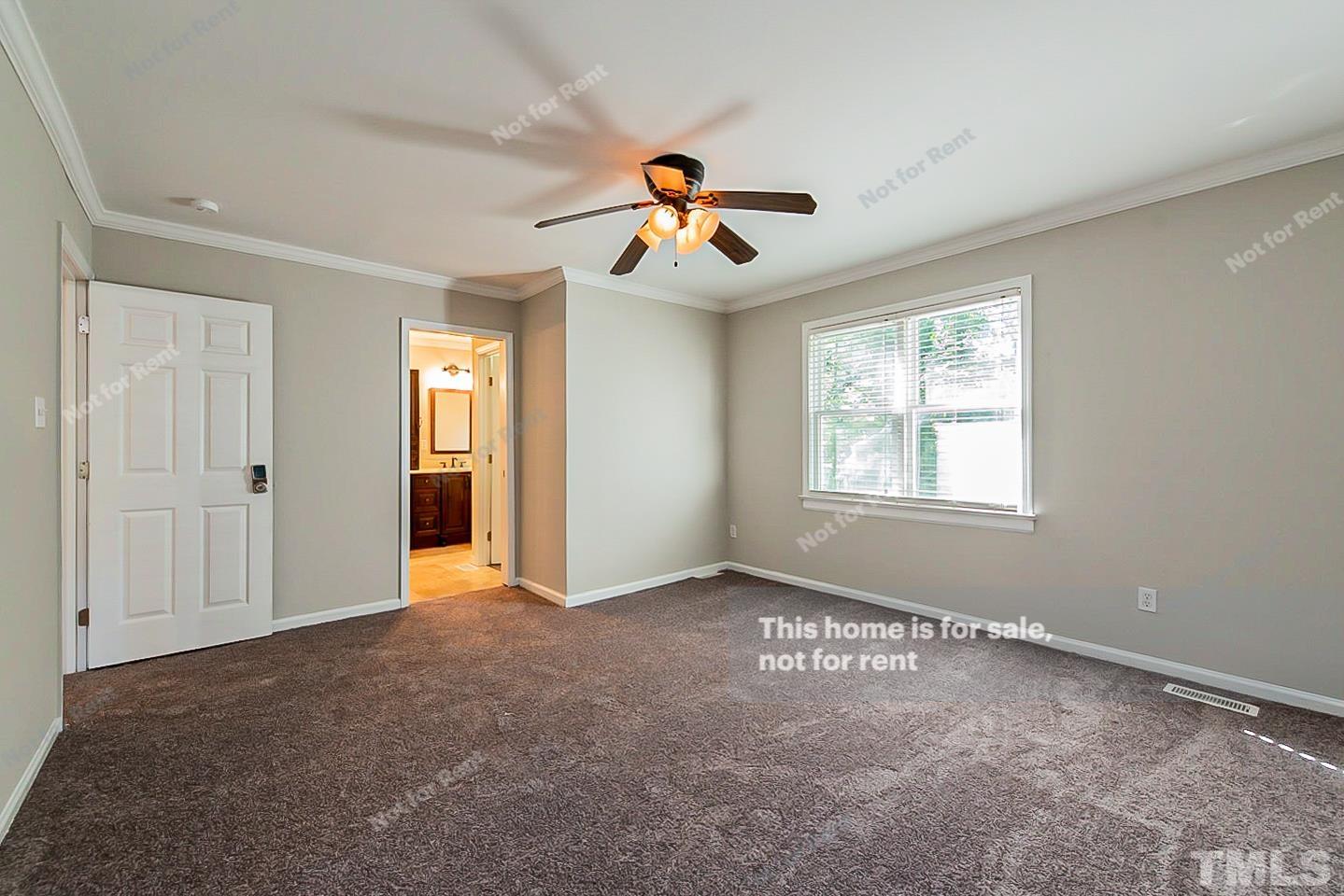 916 East Millbrook Road Raleigh, NC 27609 - Photo 12 of 24 an empty room with windows and fan