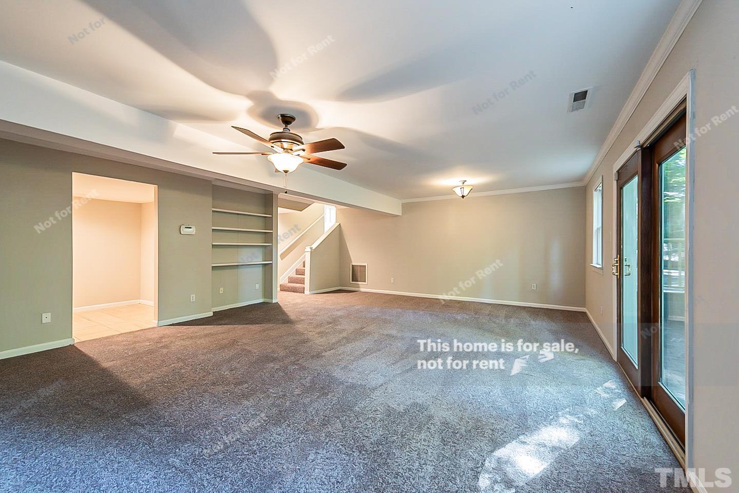 916 East Millbrook Road Raleigh, NC 27609 - Photo 13 of 24 a view of a livingroom with a ceiling fan and window