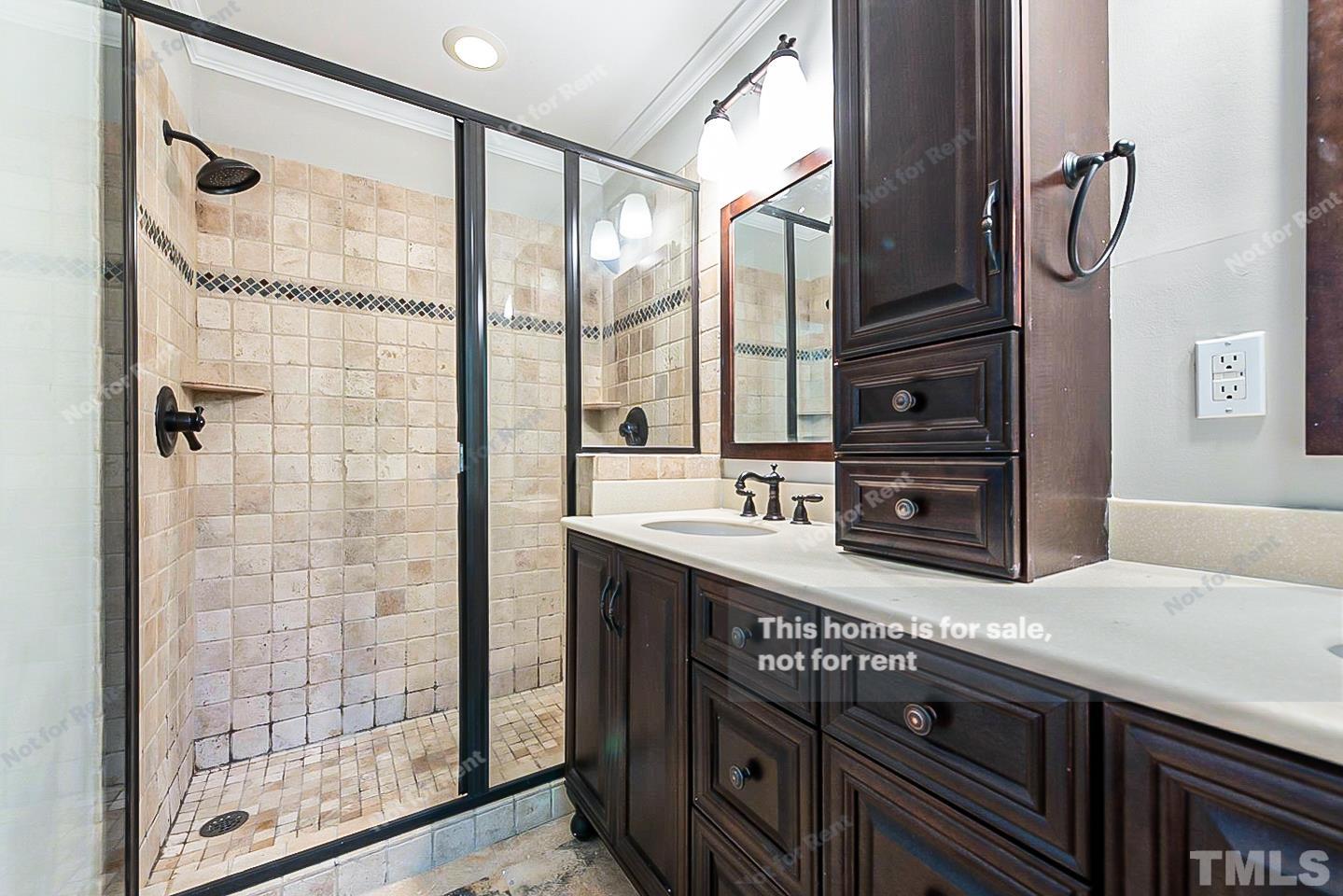 916 East Millbrook Road Raleigh, NC 27609 - Photo 16 of 24 a bathroom with a double vanity sink and mirror