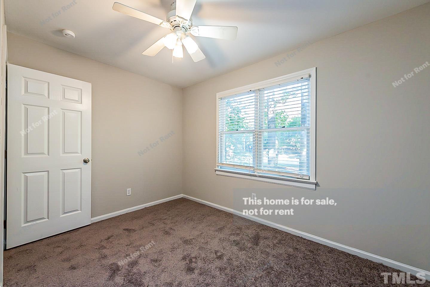 916 East Millbrook Road Raleigh, NC 27609 - Photo 18 of 24 an empty room with windows and fan