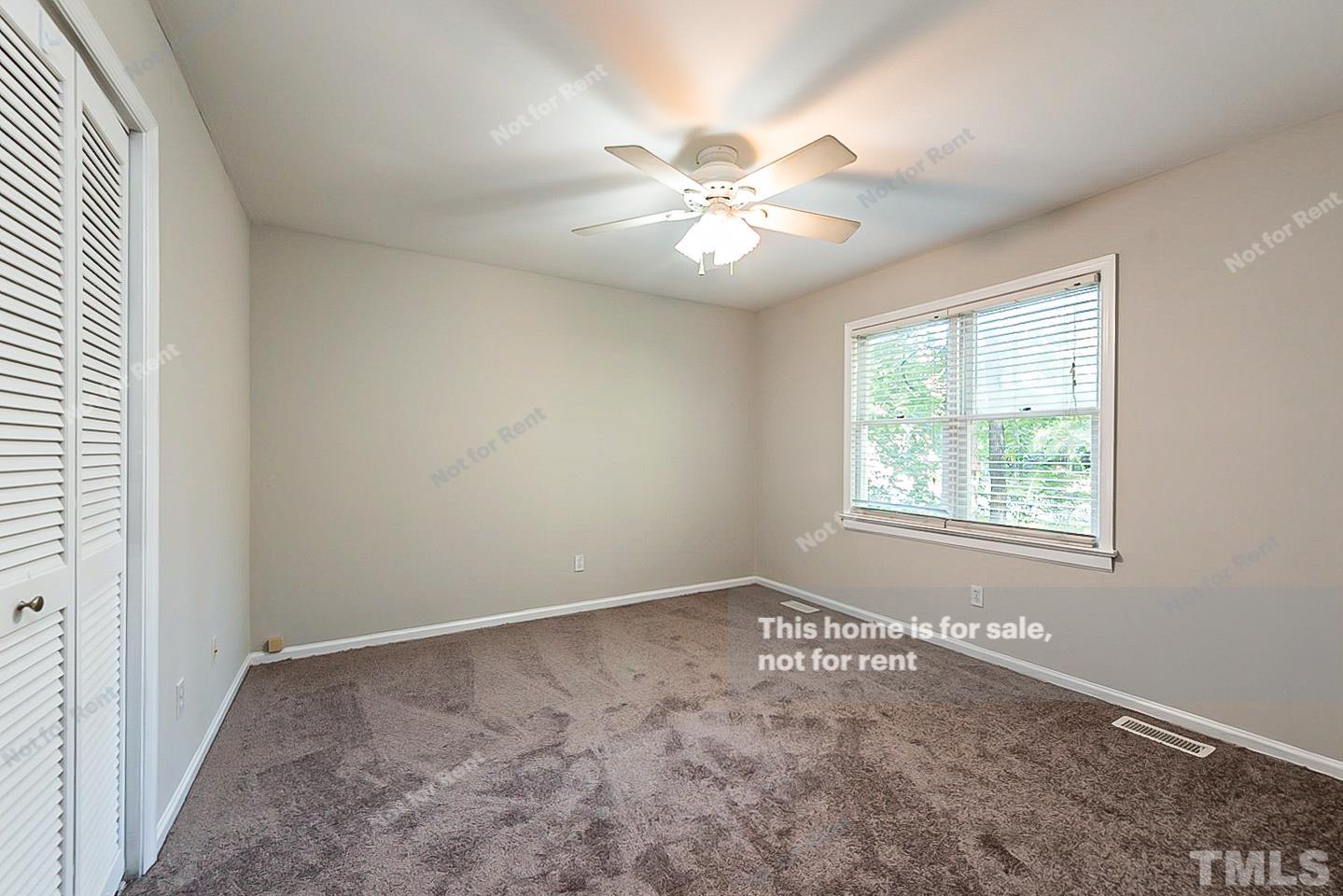 916 East Millbrook Road Raleigh, NC 27609 - Photo 19 of 24 an empty room with a window and a fan