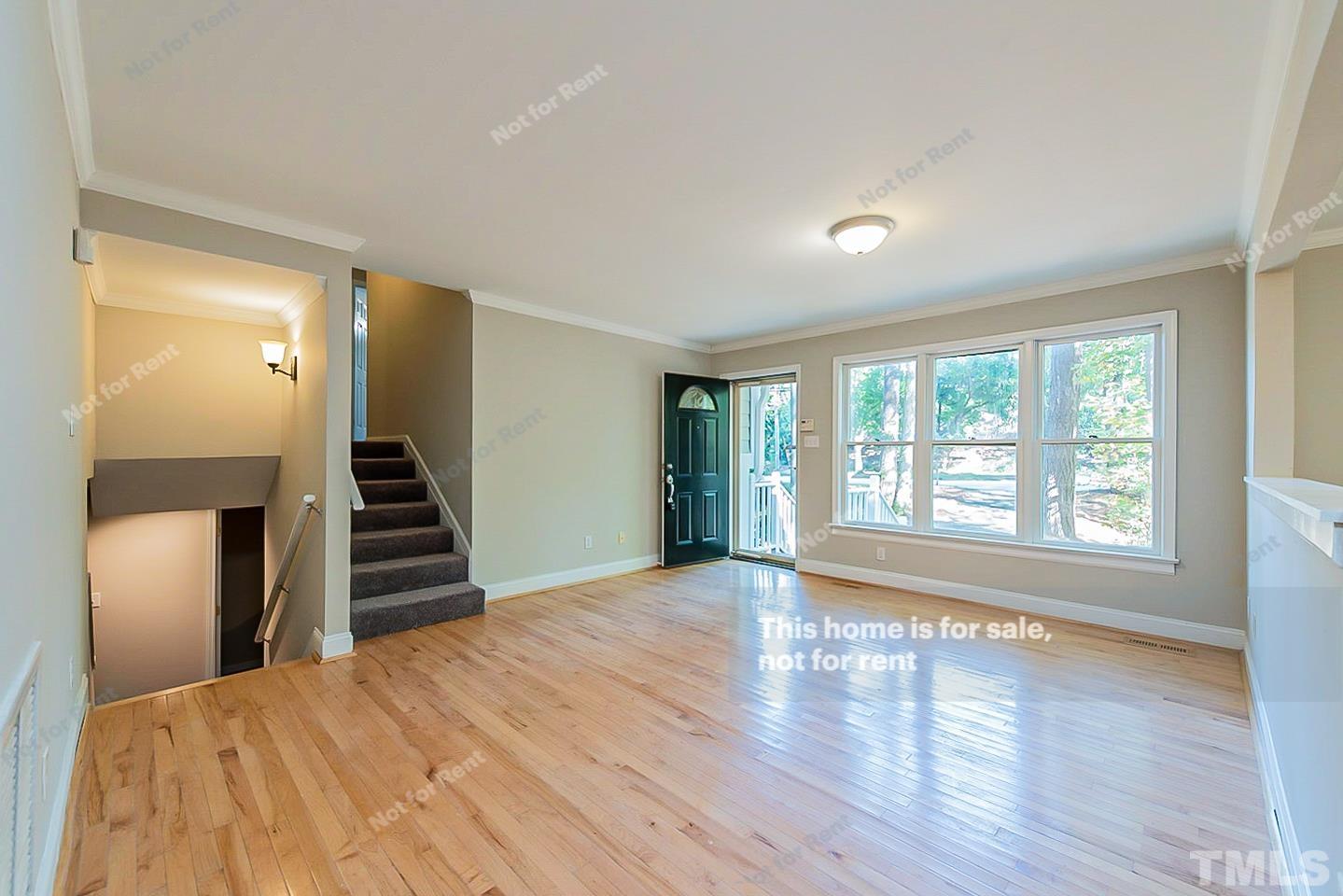 916 East Millbrook Road Raleigh, NC 27609 - Photo 3 of 24 a view of an empty room with wooden floor and stairs