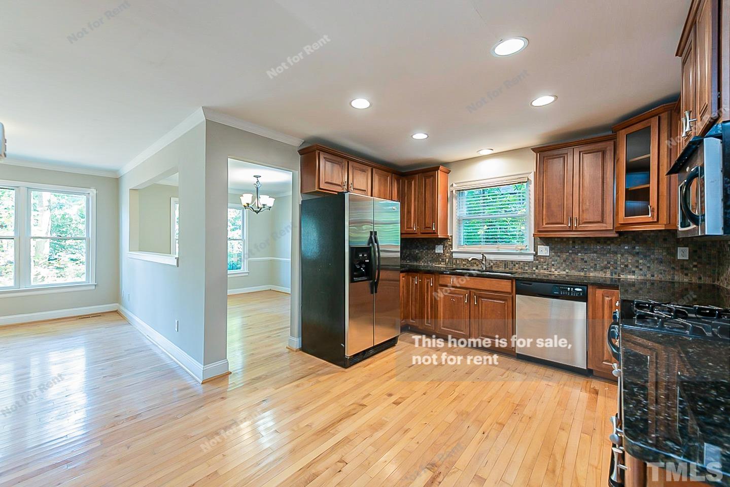 916 East Millbrook Road Raleigh, NC 27609 - Photo 4 of 24 a kitchen with stainless steel appliances granite countertop a refrigerator and a stove top oven