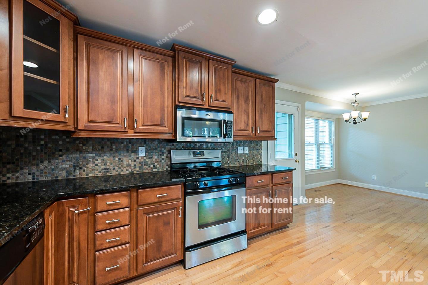 916 East Millbrook Road Raleigh, NC 27609 - Photo 6 of 24 a kitchen with stainless steel appliances granite countertop a stove a sink and a microwave