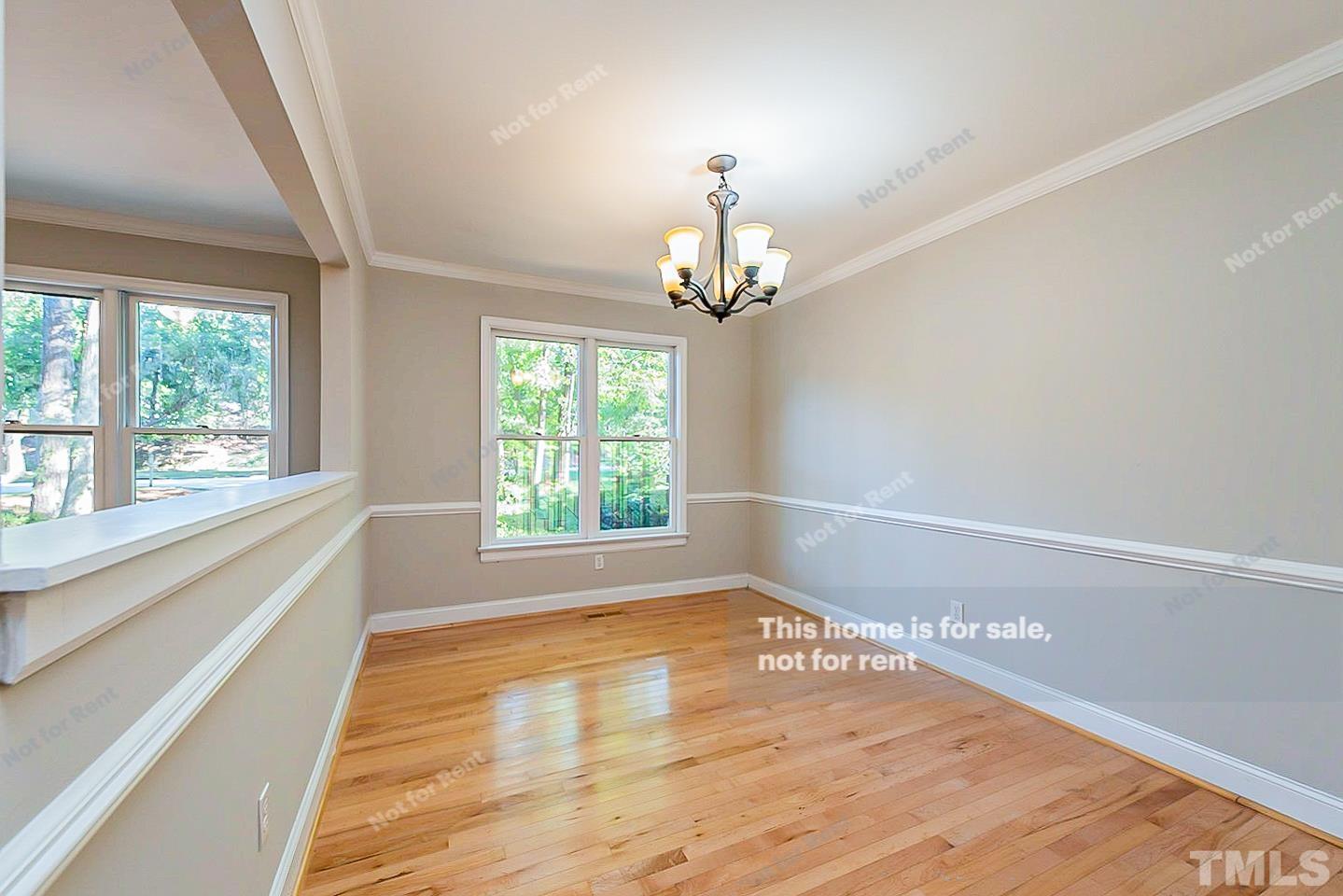 916 East Millbrook Road Raleigh, NC 27609 - Photo 8 of 24 a view of empty room with wooden floor and fan