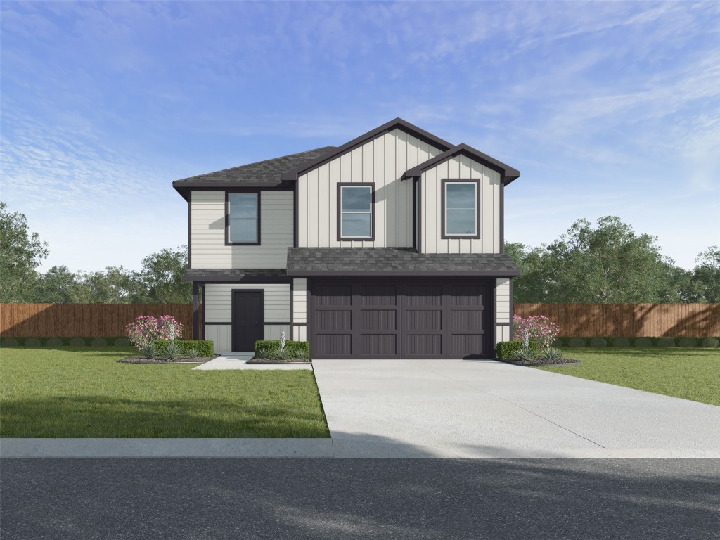 a front view of a house with a yard and garage