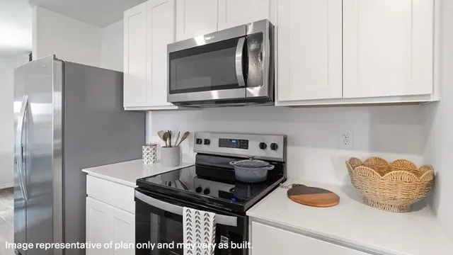 a kitchen with stainless steel appliances granite countertop a stove and a microwave