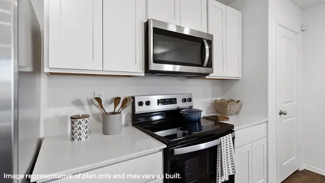 a kitchen with a stove and a microwave