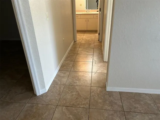 a bathroom with a granite countertop sink a toilet a mirror a vanity and shower