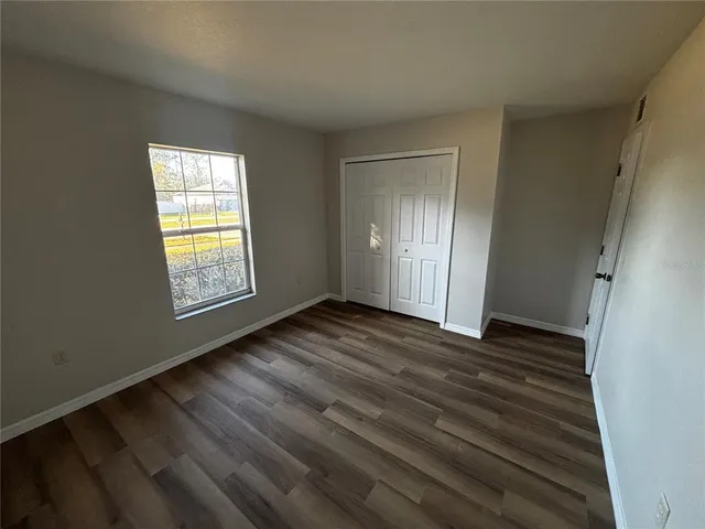 a view of an empty room and wooden floor