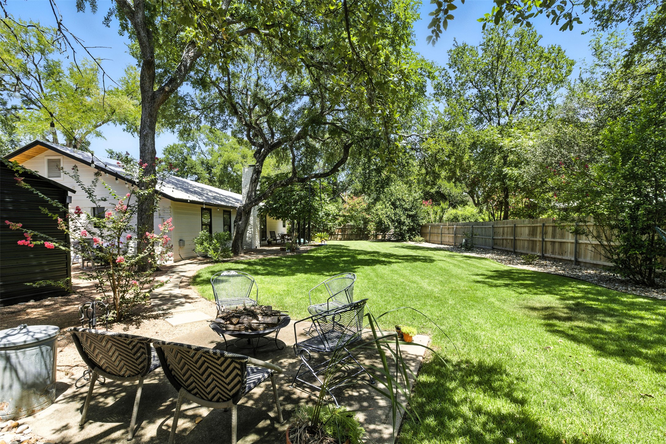 2403 Gateshead Circle Austin, TX 78745 - Photo 21 of 22 A spacious, verdant yard with mature trees offers a private outdoor retreat and fire pit area.