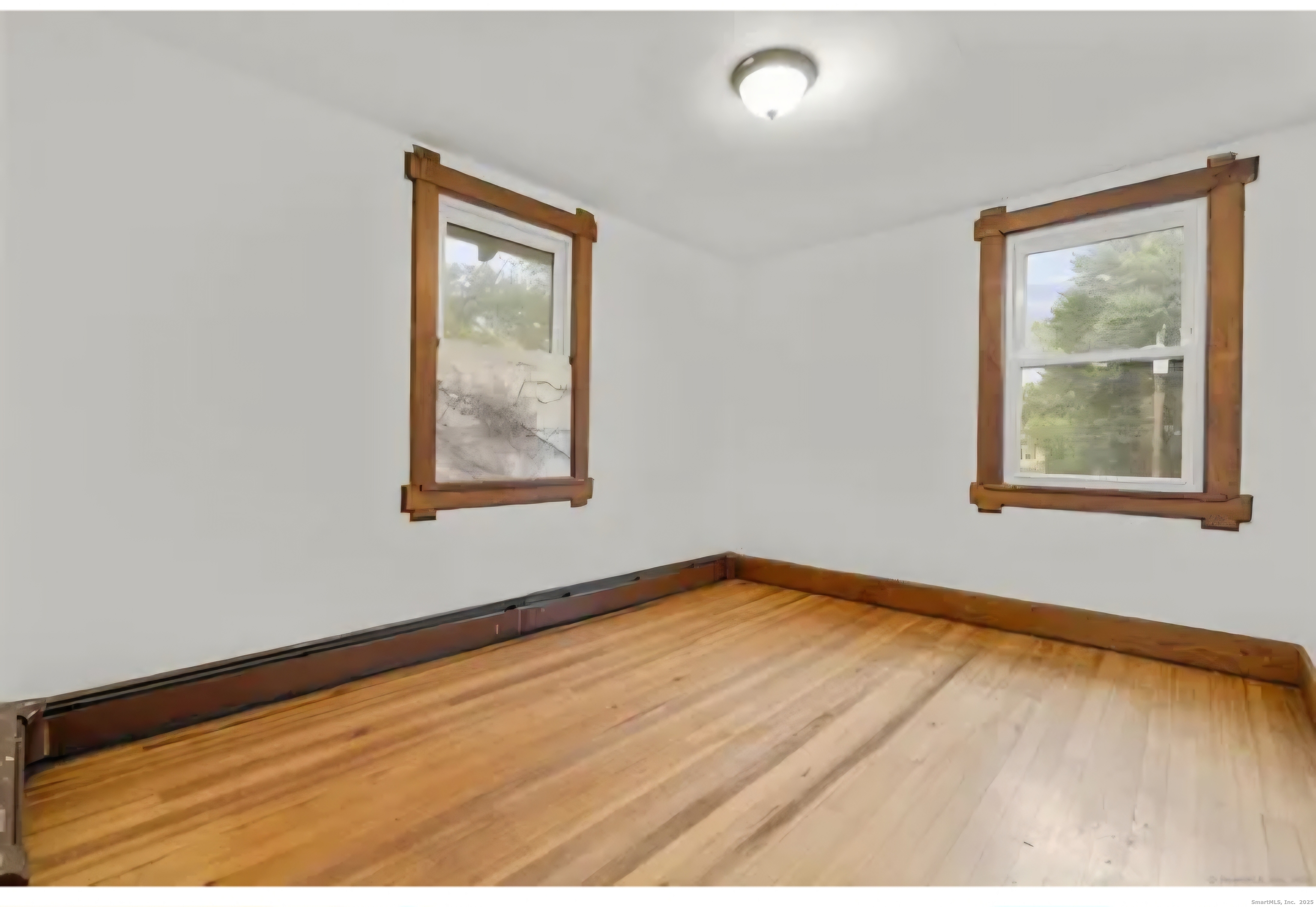 1276 North Avenue Stratford, CT 06614 - Photo 5 of 10 a view of an empty room with window and wooden floor