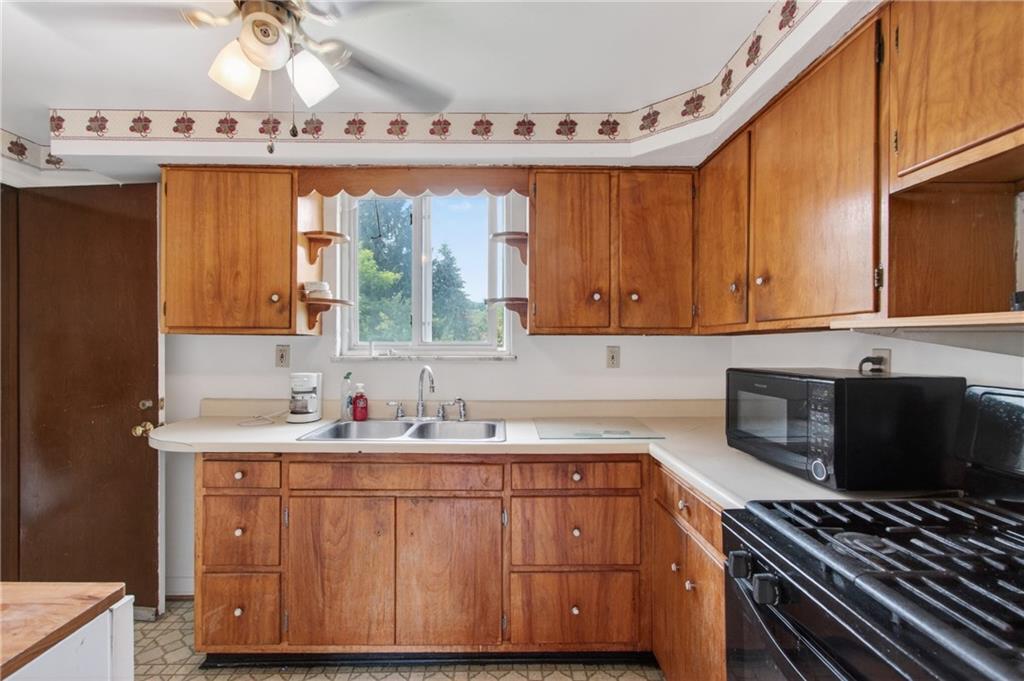 1420 Homestead Road Verona, PA 15147 - Photo 10 of 34 a kitchen with a sink a stove and cabinets