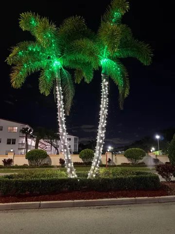 a view of a house with a yard and a street