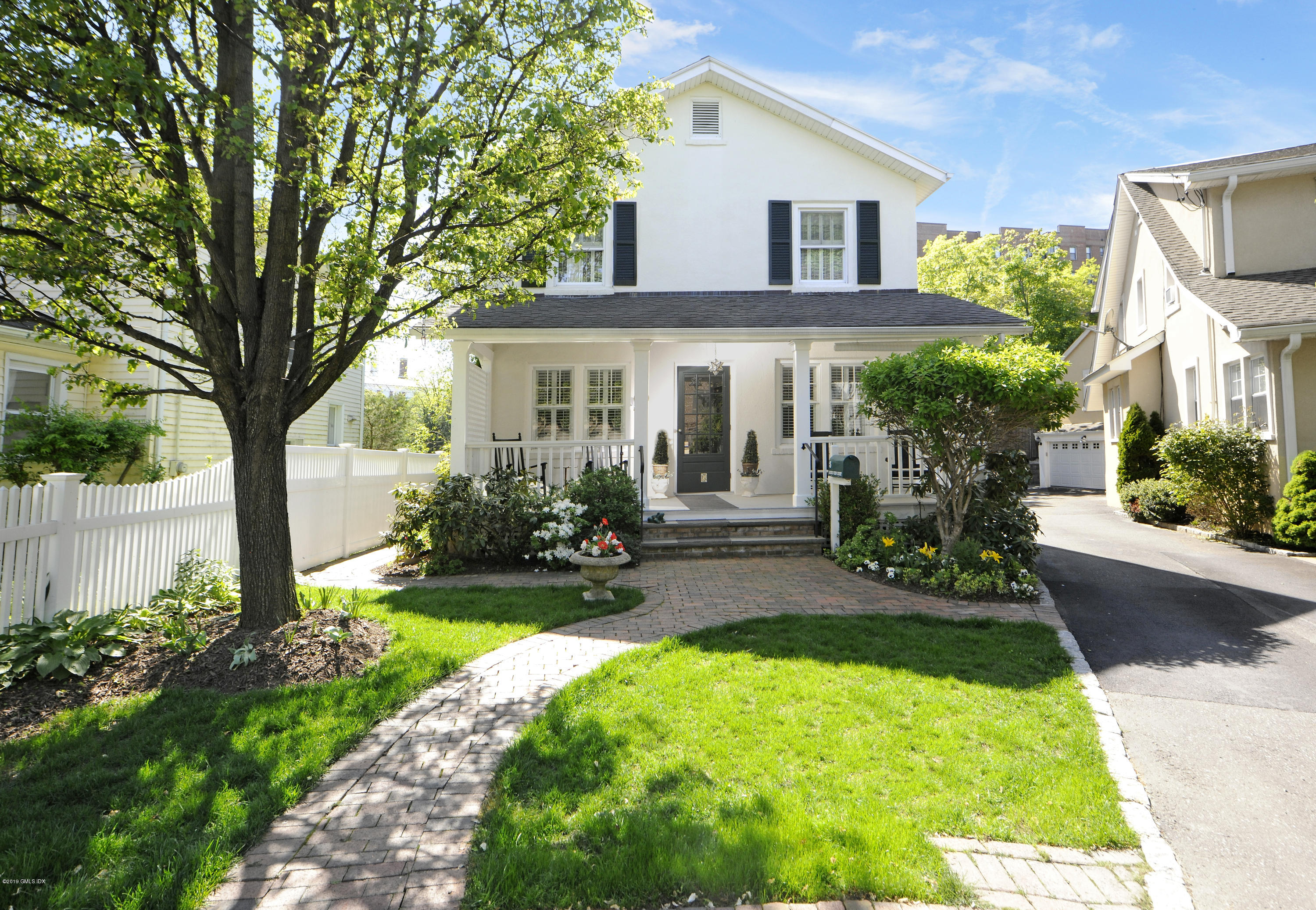 5 Sound View Court Greenwich, CT 06830 - Photo 1 of 13 a front view of a house with garden