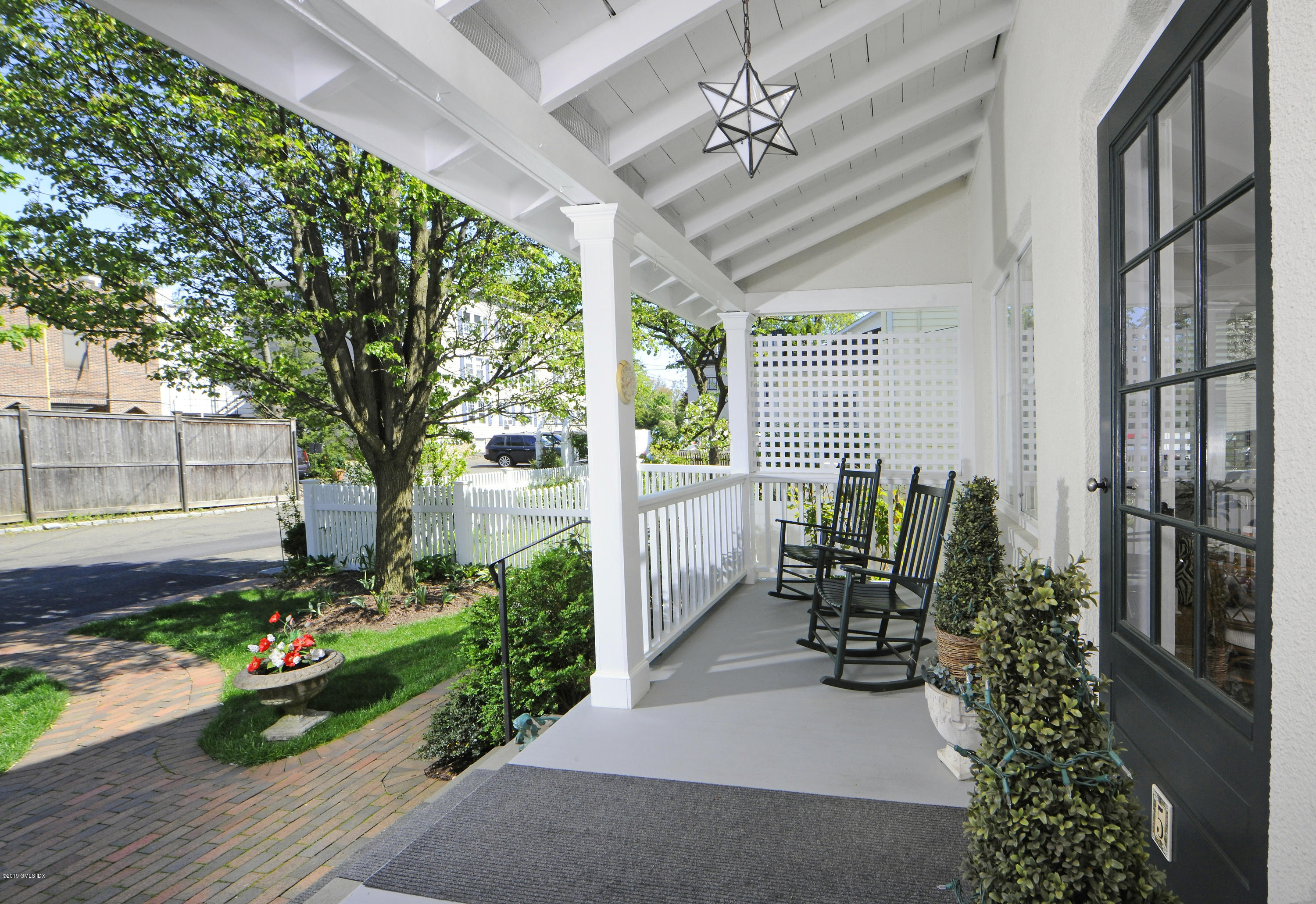 5 Sound View Court Greenwich, CT 06830 - Photo 2 of 13 a view of a porch with furniture and garden