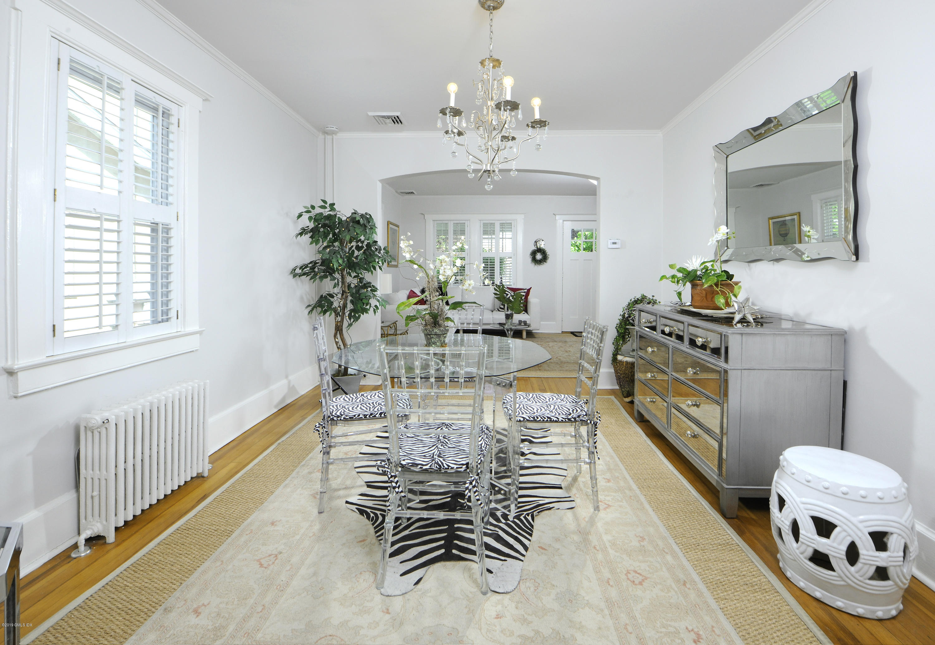 5 Sound View Court Greenwich, CT 06830 - Photo 5 of 13 a dining room with furniture a chandelier and wooden floor