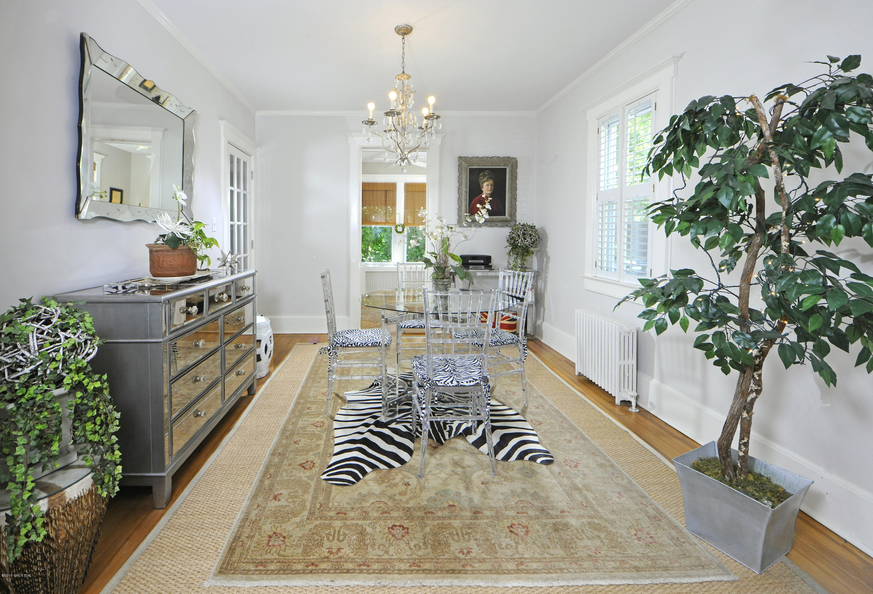 5 Sound View Court Greenwich, CT 06830 - Photo 6 of 13 a living room with furniture potted plant and a chandelier