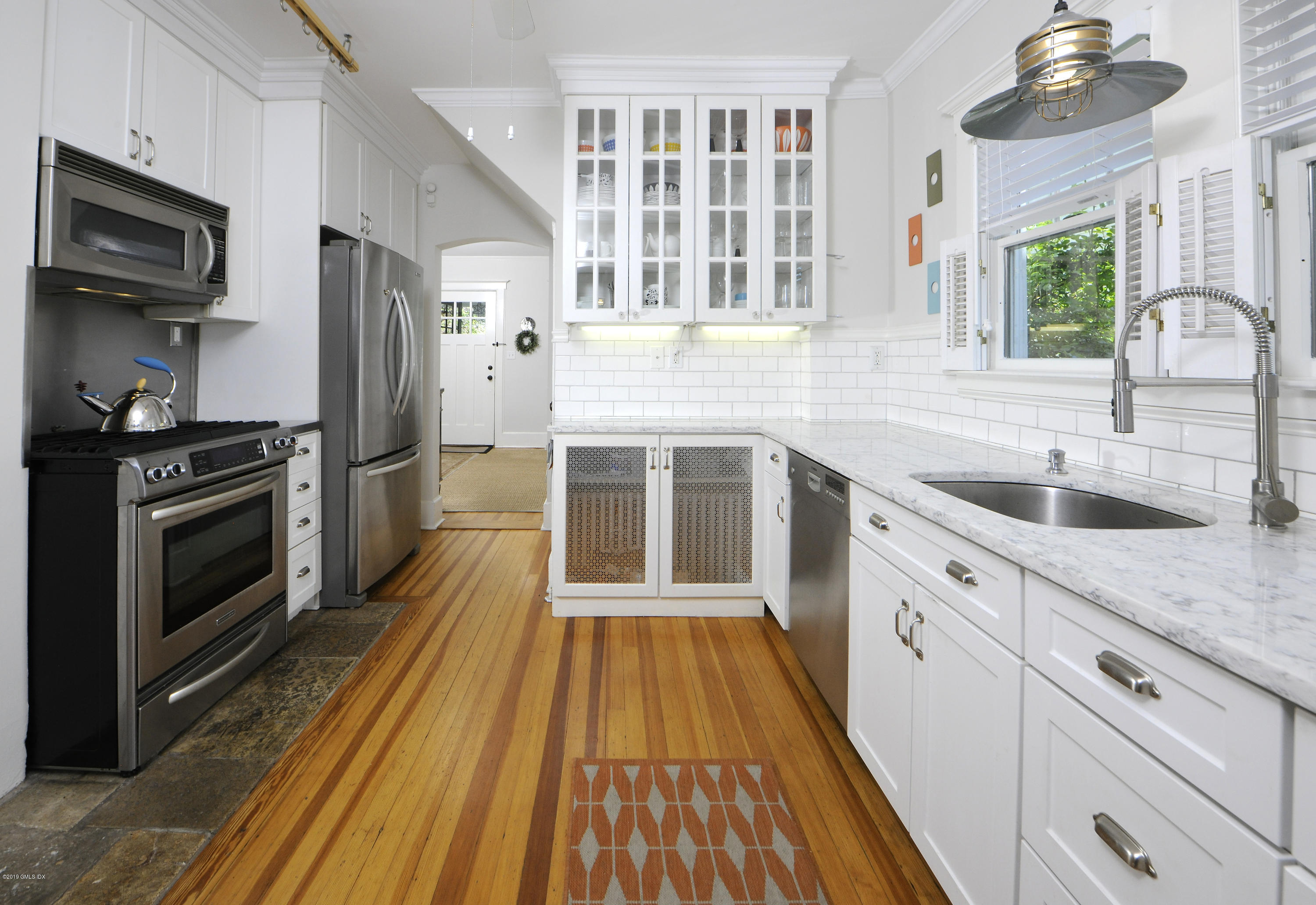 5 Sound View Court Greenwich, CT 06830 - Photo 7 of 13 a kitchen with stainless steel appliances a stove sink and refrigerator