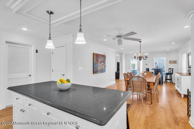 63 Fort Avenue Seaside Heights, NJ 08751 - Photo 14 of 53 a view of dining room and livingroom with furniture wooden floor a chandelier
