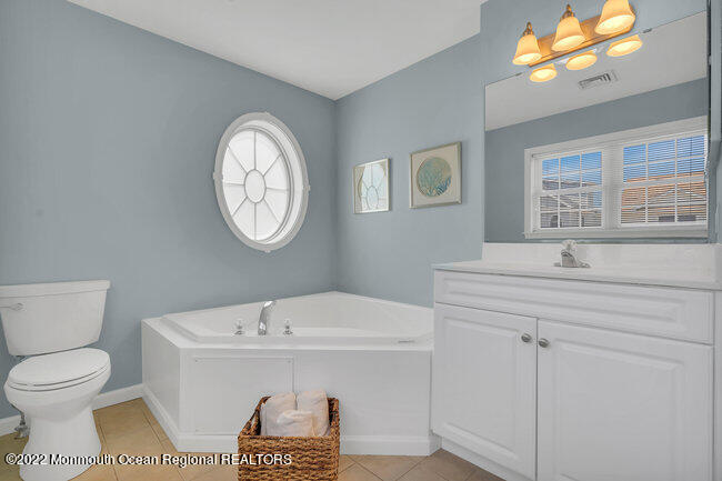 63 Fort Avenue Seaside Heights, NJ 08751 - Photo 30 of 53 a spacious bathroom with a toilet a sink and a mirror