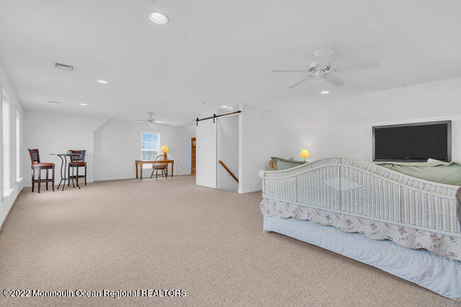 63 Fort Avenue Seaside Heights, NJ 08751 - Photo 38 of 53 a living room with furniture and a flat screen tv