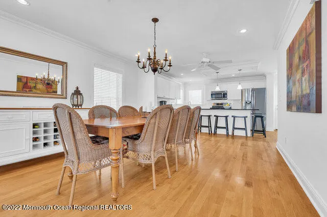 a view of a dining room with furniture wooden floor and chandelier